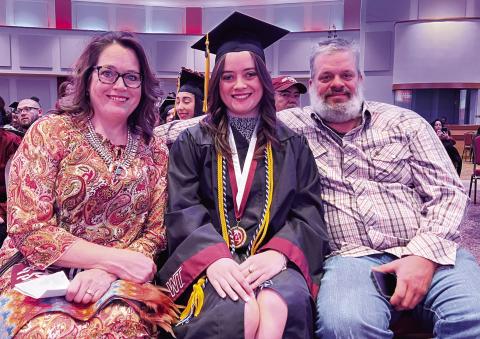 Maryann Heffley, center, accepts congratulations from her parents, Cynthia and Jason Heffley, at the West Texas A&amp;M University Donning of the Stoles ceremony.