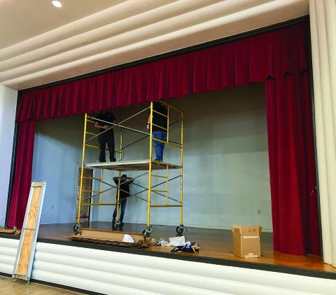 In anticipation of the opening of the new Wellington Senior Citizens Center, located in the renovated Bura Handley Community Building, the stage floor has been refinished, the walls and rafters painted and the new Skyrocket-red curtains installed. Funded by the Wellington Lions Club, the stage lighting will be installed next week. Photo by Neal Odom
