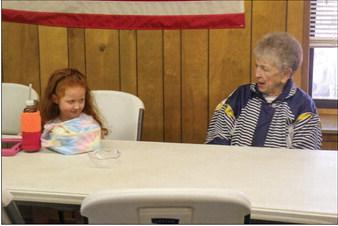 Rylee Longbine, daughter of Jacob Longbine, talks with Anne Fromm at the recent Childress Senior Citizens Center weekly luncheon. Approximately 30 seniors attended the luncheon with numerous take-out orders. Childress Senior Citizens Center Director Glenda Goundie said that anyone – regardless of age – is invited. “Bring your favorite dish or make a donation or both,” Goundie said. Photo by Grace Holman