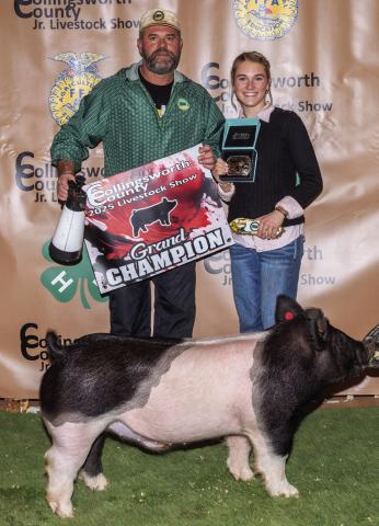 Maggie Tillman exhibits the Grand Champion Swine, assisted by her dad, Baron Tillman, and purchased by Rance Tillman at the Premium Sale.