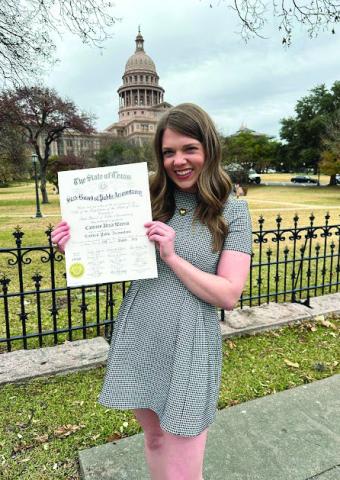 Employed by Greenbelt Electric Cooperative, Inc., Cameron Warren receives her Certified Public Accountant certificate during a January ceremony at the Palmer Events Center in Austin. Courtesy Photo