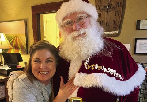Beverly Smith visits with Santa Claus at The 501 Winery, located in downtown Childress. The Red River Sun/Nicole Dill