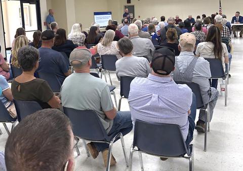 Residents listen to a Lancium representative discuss a plan to bring new water to the Greenbelt system Tuesday. INTREPID PHOTO / AARON RAMOS
