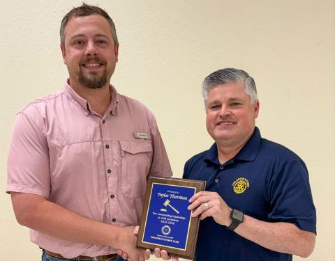 The Childress Rotary Club, represented by Reagan Garrison, honors President Taylor Thornton, left, for an outstanding year of leadership and dedicated service. CHILDRESS ROTARY CLUB