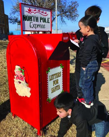 The sons of Tino and Shauna Salinas, Dahmian, Alejandro and TJ Salinas, come up with a plan to get a letter to Santa. Photo by Neal Odom