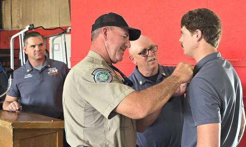 Tanner Thompson was promoted to Lieutenant and pinned by Chief Freeman and his father, Game Warden Matt Thompson, as Asst. Chief Wills looks on. INTREPID PHOTO / ROGER ESTLACK