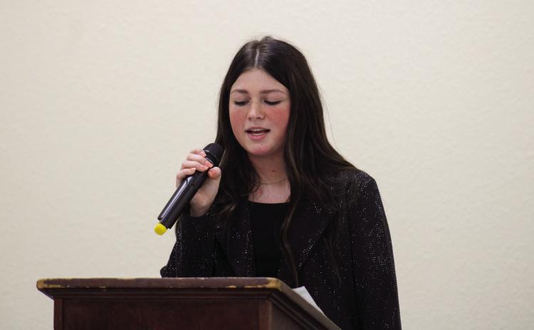 Quanah’s Lacy Teichroeb, daughter of John and Lena Teichroeb, performs at the Childress Rotary Club luncheon Thursday, Feb. 16 at Fair Park City Auditorium. Teichroeb performed “Dear Miss Loretta” by Carly Pierce, followed by a host of Loretta Lynn charttoppers, including “You’re Lookin’ At Country,” “They Don’t Make ‘em Like My Daddy,” “Fist City” and “Coal Miner’s Daughter.” The Red River Sun/Elizabeth Tanner