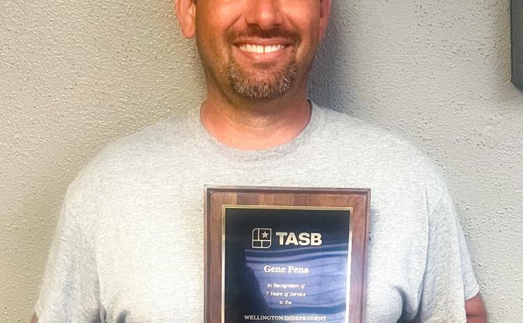 Wellington Independent School District (ISD) Trustee Gene Pena accepts a plaque for seven years of service, 2019-2026. On behalf of Texas Association of School Boards (TASB), Wellington ISD Superintendent Kurt Ashmore made the presentation during the Monday, April 13 meeting. Pena did not seek reelection for another term. WELLINGTON ISD