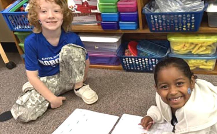 Miss G’s first graders work with a partner to practice reading skills recently. CHILDRESS ELEMENTARY
