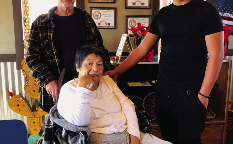 Jerry, Mona and Elijah Granados gather in the dining room of Mona’s Firehouse Cocina for one last time Friday afternoon, Dec. 20 on 8th St. in Wellington. The decline in her health caused the family to make the difficult decision to close the restaurant. The Red River Sun/Bev Odom