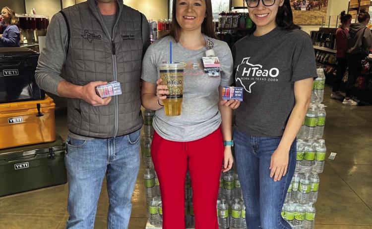 Candice Willis, center, wins HTeaO’s “Free Tea for a Year” giveaway, announced Tuesday, March 14. “Thank you, HTeaO,” Willis said. “I’m thankful and excited.” HTeaO co-owners Vandon Vest, left, and Soni Vest, right, award her with the prize. Photo Courtesy of HTeaO