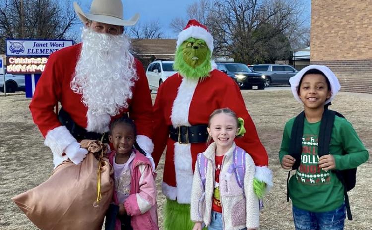 Santa, his helpers and the Grinch visit Childress Elementary