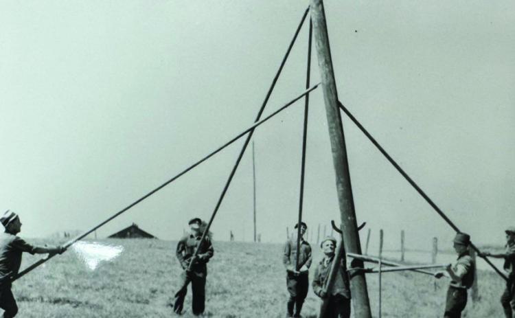 When Orvile Couch first started the electric co-op, experienced contractors had to be hired to build the line. “We would hire day labors and pay them $5 a day just to dig pole holes,” Greenbelt Electric Cooperative General Manager Randy White said. “We later purchased an auger that we drug around on a trailer to dig the holes but still had to set up the pole with these pole pikes.” Photo Courtesy of GEC
