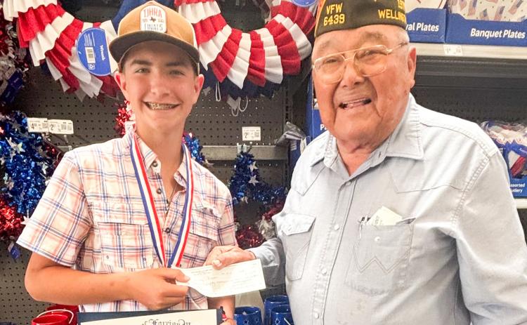 Childress High School freshman Quay Bruce accepts accolades from Wellington Glynn Moore Veterans of Foreign Wars (VFW) Post 6439 Quartermaster Jr. Castillo. Bruce won the Patriot’s Pen essay contest at the Post level, and his essay advanced to the VFW District 9 level that encompasses the Texas Panhandle. Castillo presented Bruce with a $150 award and a certificate. COURTESY PHOTO