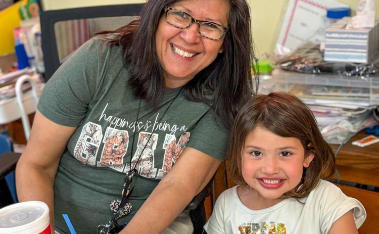 Austin Elementary School first-grade student Astrid Benetiz cashes in her Classroom Hero points to have lunch with her teacher, Norma Ross. MEMPHIS ISD