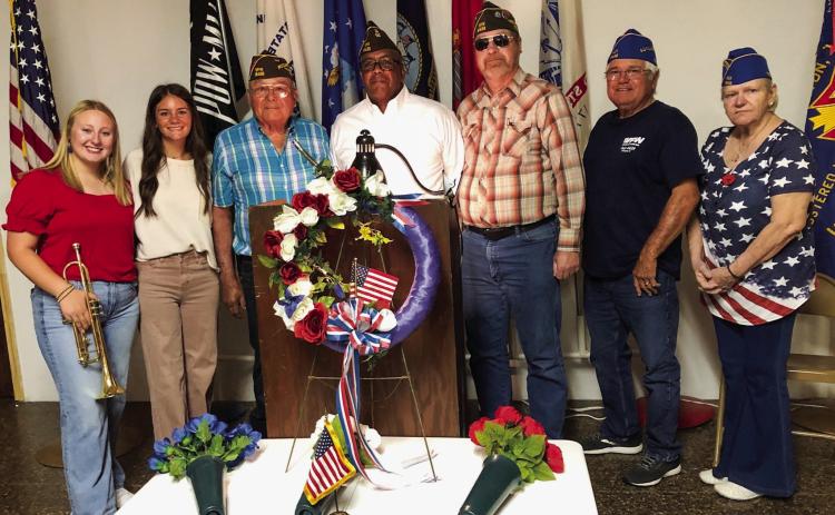 Glynn Moore Veterans of Foreign Wars (VFW) Post 6439 hosts the 2025 Collingsworth County Memorial Day Service at 11 a.m. Monday, May 26 at the Post Hall. Program participants gather amongst the Remembrance Ceremony wreath and flowers following the service. From left: Trumpeter Allie Duncan, Vocalist Heather Peters, Quartermaster Epifanio “Jr.” Castillo, Commander Rodney Bishop, Chaplain Jeff Pastor, Auxiliary President John O’Rear, Auxiliary Trustee Jane Campbell. The Red River Sun/Bev Odom