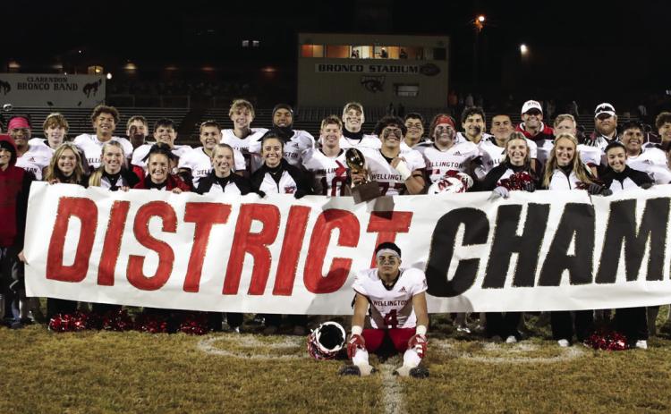 The Wellington Skyrockets display their District 2-2A Division II Championship trophy on a chilly Friday, Nov. 4 following a 44-8 win against the Clarendon Broncos. Lukas Wilbur Photography