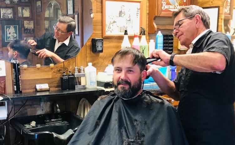 Clarence Duke recalls his first haircuts as a kid from Jim Ellis at Dick Judd’s Barber Shop, where Jim began his career in 1987. Duke slipped in for a final haircut on Jim’s last day of business, Friday, Dec. 29. The Red River Sun/Bev Odom