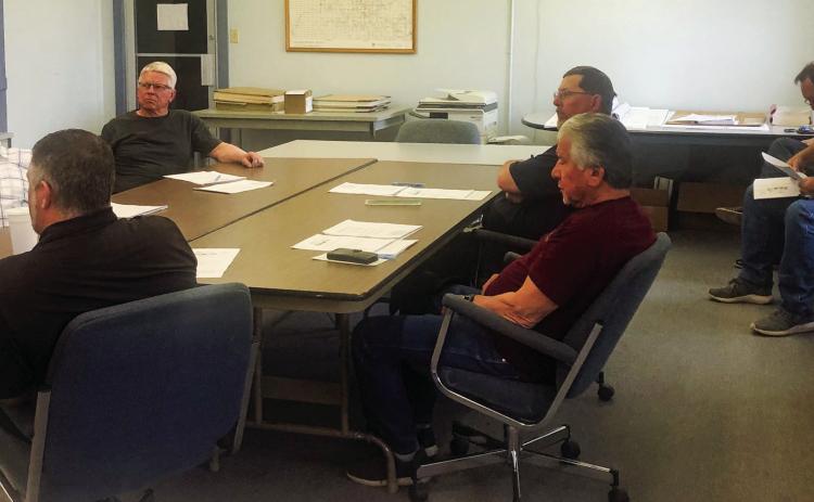 Wellington Councilman Brandon Ward, clockwise from left, Mayor Larry Adams, Councilmen Kenneth Warren, Brent Martin and Jimmy Cantu Jr. and visitors Clint Thomas and Cliff Waller listen as City Manager Jon Sessions gives his City Manager’s report. The Red River Sun/Bev Odom