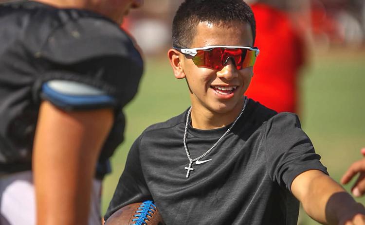 An A honor roll student, Wellington High School senior Dahmian Salinas greets his Skyrocket football teammates at practice and maintains his position of manager. Last February, Dahmian suffered a severe brain injury in a freak baseball accident. AUSTIN HARTSFIELD/SIDELINE SPORTS