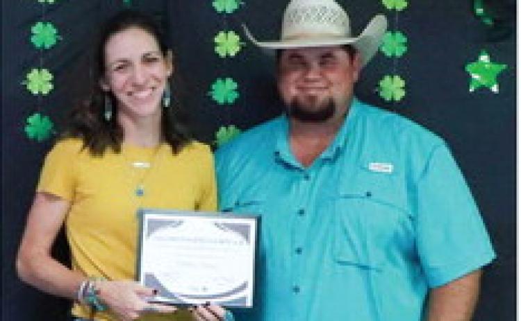 Texas A&amp;M AgriLife Extension Service of Collingsworth County Ag and Natural Resources Agent Kenny Patterson, right, presents Molly Sims the 2023-2024 Distinguished Leader merit.