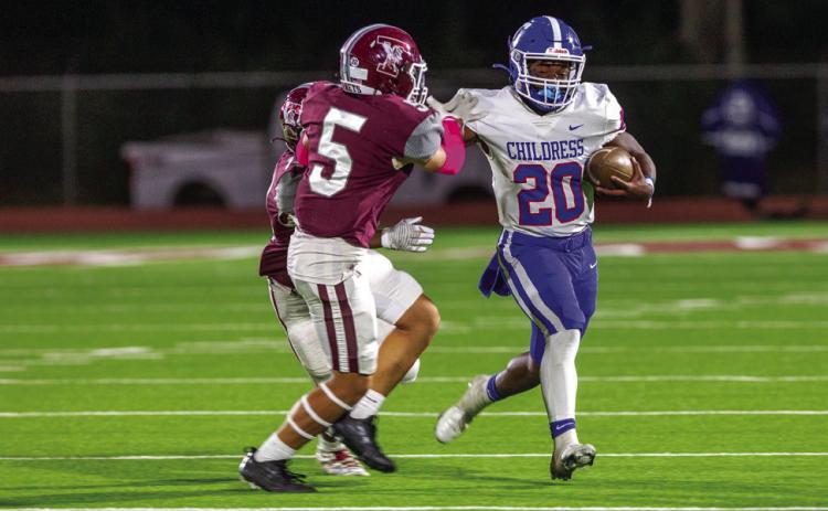 Childress running back Dareon Mathis (20) gains yardage for the Bobcats while warding off Tulia defensive back Timmy Trevino (5) Friday, Oct. 14 at Younger Field. The Red River Sun/Nicole Dill