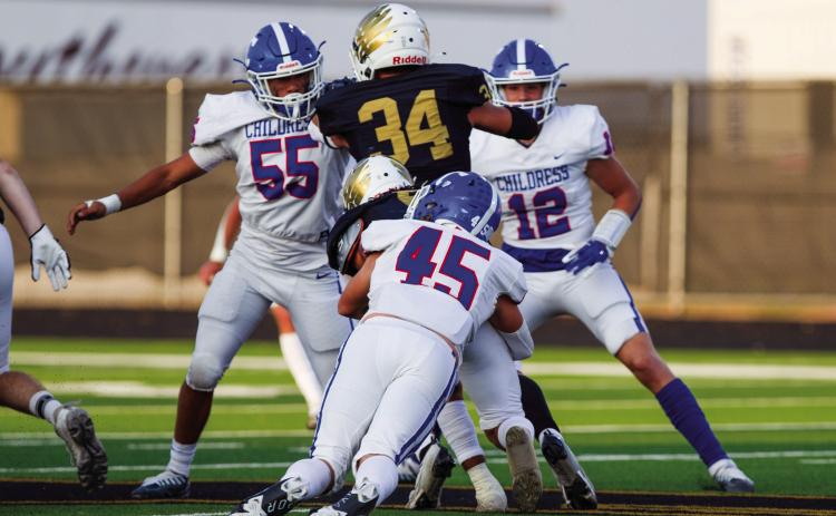 Childress’ Reid Felton (45), Isaac Salinas (55) and Seth Taylor (12) work to take down Bushland’s Stockton Blount (5) and Breckan Reed (34) during the 43-0 matchup Friday Sept. 9 at Falcon Stadium. The Red River Sun/Nicole Dill