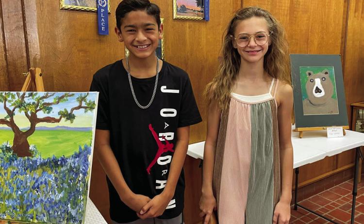 Moore Art Studio students Ivan Garcia, 11, and Selah Smith, 11, display their art at For The Hub of Art Youth Art Show, held Saturday, Sept. 17 at the Childress County Heritage Musuem. Courtesy Photo
