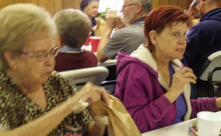 Maxine Skinner, left, and Deloris Trevino were among the 50 seniors who attended the annual Easter Luncheon Thursday, April 6 at the Childress Senior Center. A traditional Easter feast, including ham, chicken and dressing, along with a variety of side dishes, was served. Highlighting the dessert table was an iced white sheet cake adorned with a spring floral motif. The Easter Bunny also gave each guest a brown bag of assorted candies. Photos by Grace Holman