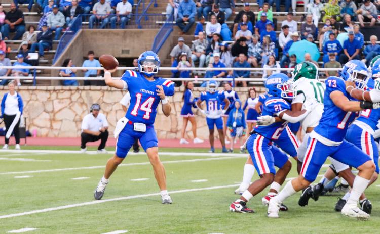 Childress quarterback Koen Galligan looks to make a connection with wide receiver Benton Sims during the Bobcats’ 21-14 win over Breckenridge Friday, Sept. 5 at Fair Park Stadium in Childress.