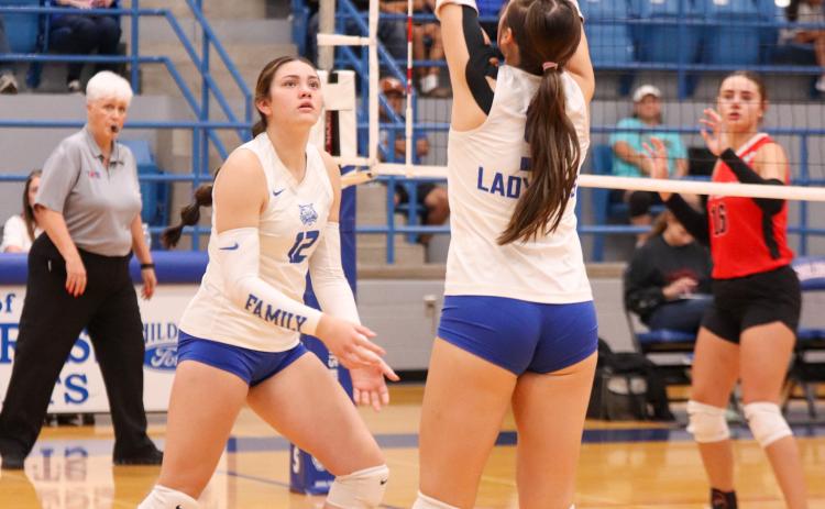 Childress’ Sara Davis sets the ball for middle blocker De’Edra Miller in the Lady Cats’ 3-1 win over the Fort Elliott Lady Cougars Friday, Sept. 5 in Childress.