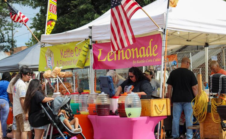 Attendees shop over 40 vendor booths, including Kettle Corn Cuties, during the 90th Annual Hall County Picnic Saturday, Sept. 20 in downtown Memphis.