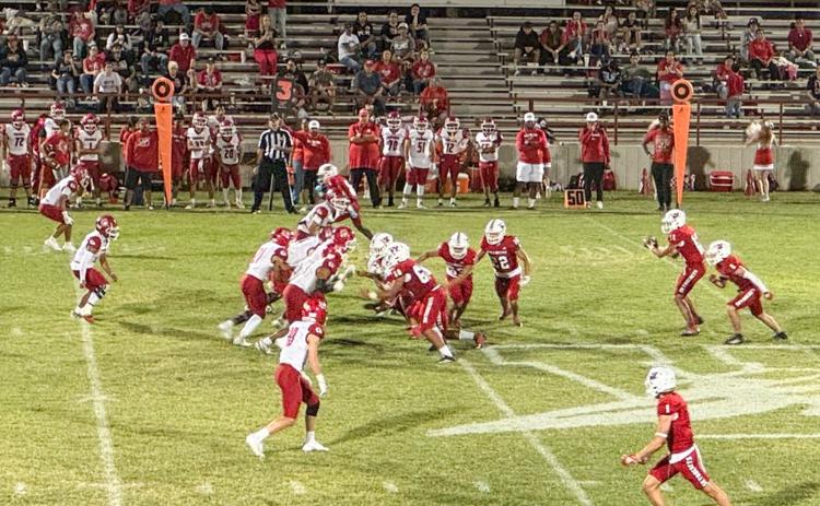 Wellington quarterback Callen Kane receives the ball and completes the pass, amassing 240 yards passing during the Skyrockets’ 48-28 homecoming win against Friona Friday, Sept. 12 at Powell Field in Wellington.