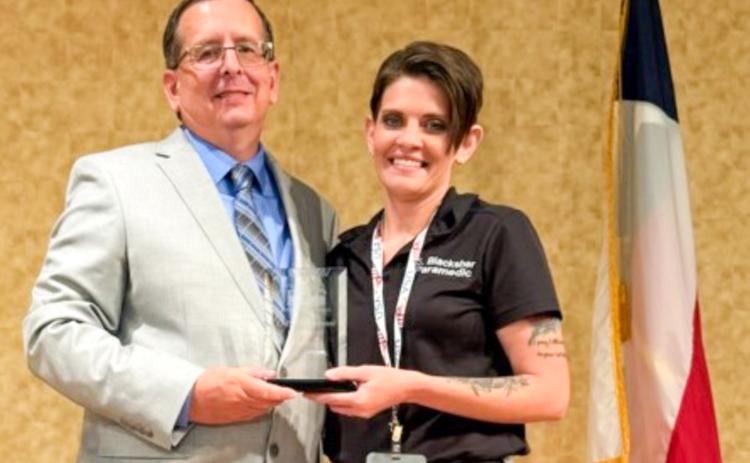 Presented by Director of Operations Howard Heath of the Panhandle Regional Advisory Council (P-RAC), Wellington Emergency Medical Services Administrator Samantha “Sam” Blacksher accepts the Texas Panhandle EMS Professional of the Year honor on Thursday, Sept. 18 at Amarillo Civic Center.A graduate of Samnorwood High School, Blacksher obtained her nursing degree at Clarendon College.
