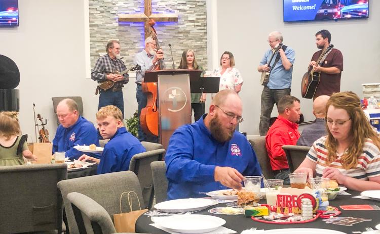 The Sain family, including, from left, Mort Sain, Oran Sain, Donna Lewis, Misty Cummings, Jeremy Sain and Jeffrey Lewis, perform old hymns in a Bluegrass style Sunday evening, Sept. 28, as entertainment during the Collingsworth County First Responder Appreciation Dinner, hosted by Calvary Baptist Church.