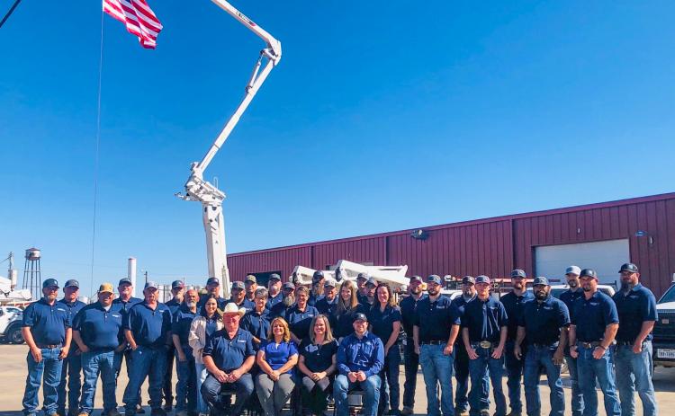 As Old Glory waves in the wind, the Greenbelt Electric Cooperative staff gathers Friday morning, Oct. 26, prior to its 86th Annual Meeting drive-through event.