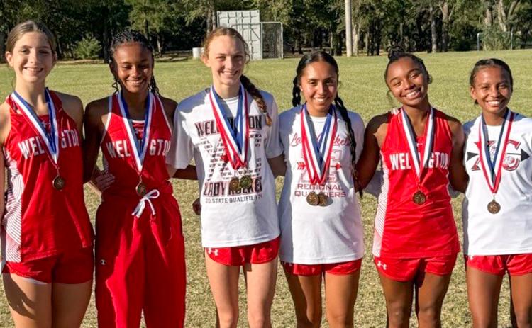 Wellington High School sophomore Taytum Kane claimed the district cross country championship, setting a new personal record of 12:07.49, at the District 2-2A Cross Country Championship Wednesday, Oct. 8 in Wheeler. From left: Anna Henard, Angela Lewis, Taytum Kane, Sabrina Segovia, Aleah Lewis, Kobee Lewis.
