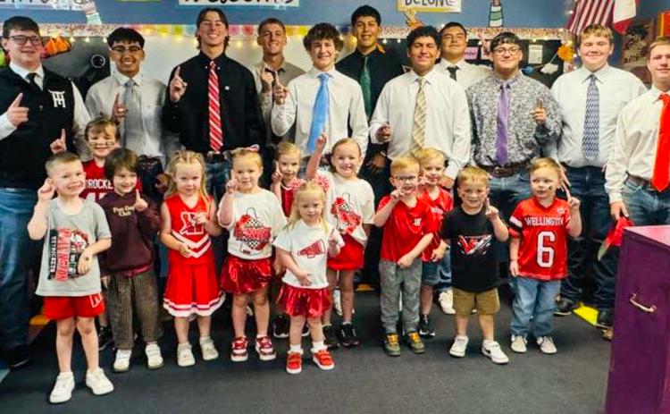 The varsity Wellington Skyrocket football team makes rounds at Wellington Elementary School, visiting with Megan Wisckaemper’s pre-kindergarten students, Friday morning, Sept. 26, prior to the Skyrockets’ home matchup against Panhandle, where Wellington took a 41-0 blank, falling in their first non-district loss of the season.