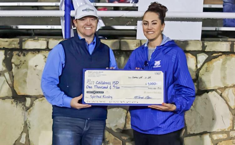 First United Bank Assistant Vice President and Childress Branch Manager Alabama Bohannon presents Childress High School Principal Keely Hackler with a check totaling $1,000 Friday, Oct. 24 at Fair Park Stadium in Childress.