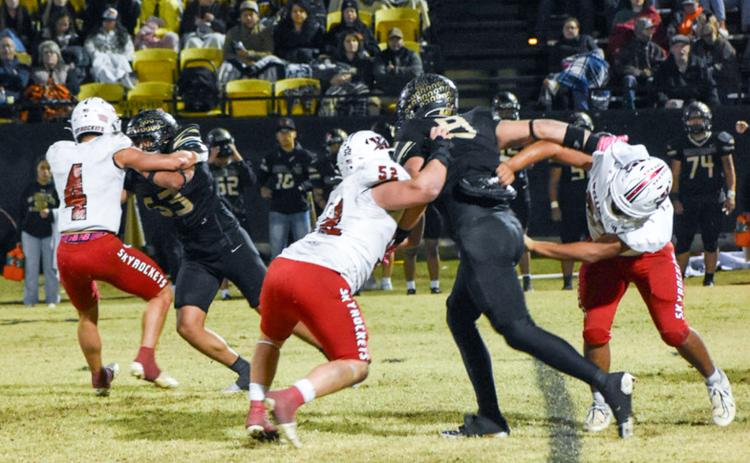 Fighting for the district championship title, Wellington’s Noah Cantu (4), Hunter Hedrick (52) and Elijah Granados (67) slow down the Wheeler Mustang offense for a Friday night, Oct. 31, where the Skyrockets fell 12-0 on the road.
