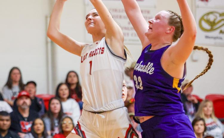 Lady Rocket sophomore Kambrie Fisher (1) fights for a scoring position against the No. 1 state-ranked Panhandle Lady Etts last Friday night, Jan. 9 in Wellington. The Lady Rockets held their own, as Panhandle had only a two-point lead at halftime, but came up shy, 48-39, as the final buzzer sounded.