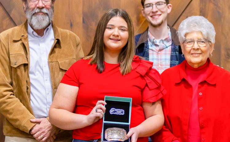 Wellington High School senior Jacy Lampe receives the Herdsmen Award in honor of the late Don Reeves during the Collingsworth County Livestock Association’s dinner and sale Saturday evening, Jan. 17 at the Bura Handley Community Center. From left: Wes Reeves, Jacy Lampe, John Reeves, Katherine Reeves.