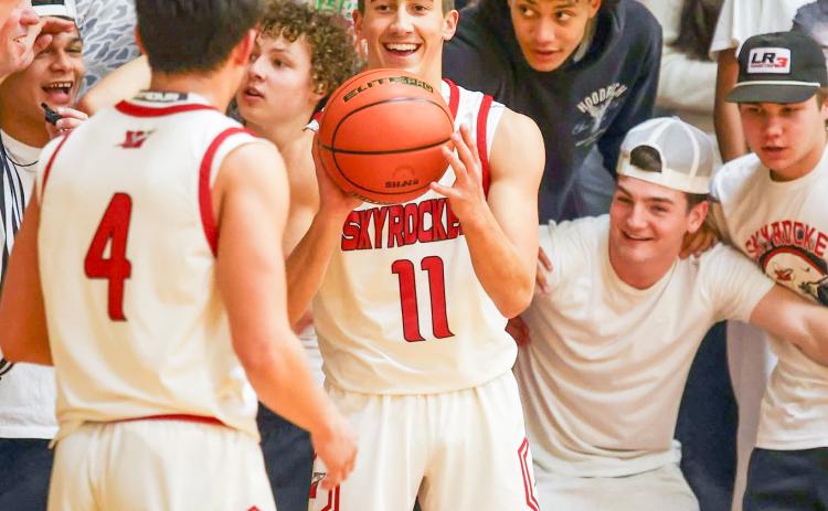 Wellington fans cheer on the Skyrockets in the Friday, Jan. 9 matchup versus Panhandle as junior Callen Kane (11) passes the ball to senior Noah Cantu (4). The Panthers took the 60-48 win.