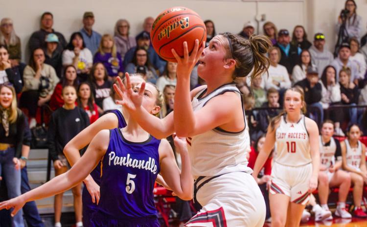 Lady Rocket Ceighley Killian (11) goes up for the shot, with Bryn Phillips (10) close at hand for the rebound, in Wellington’s close 34-26 loss to the Pantherettes on Tuesday, Feb. 3 in Panhandle.