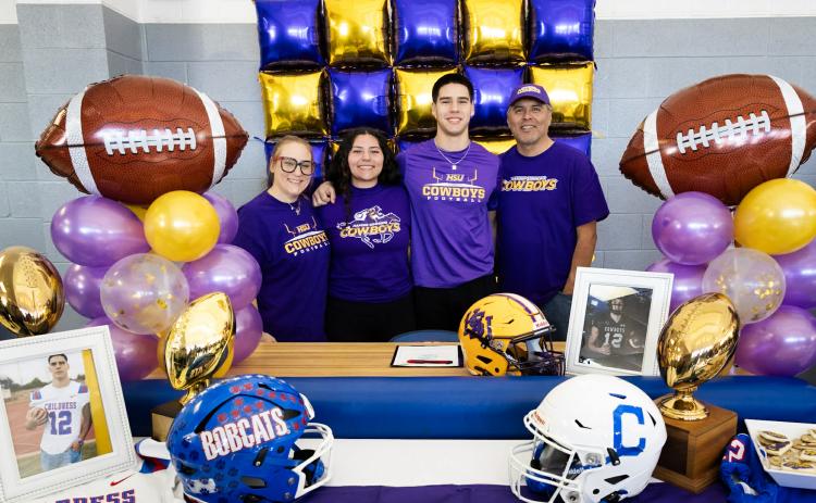 Childress High School senior Jacob Mora sings a National Letter of Intent to continue his football career with the Hardin-Simmons University Cowboys Thursday, Jan. 29 in the Childress High School gymnasium foyer.