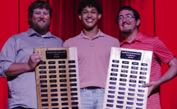 Junior Brenden Garcia accepts the Distance award for track, presented by Coach Creighton Henderson, and the Offense award for basketball, presented by Coach Quenton Patterson at Wellington High School’s (WHS) All-Sports Banquet at 6:30 p.m. Thursday, May 17 at the WHS auditorium. The Red River Sun/Shauna Salinas
