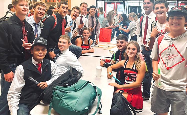 Wellington High School Principal Deidre Kane passes out popsicles during break in the Commons on Friday morning, Aug. 28, pumping up the student body for the Skyrockets versus Spearman Lynx football game.