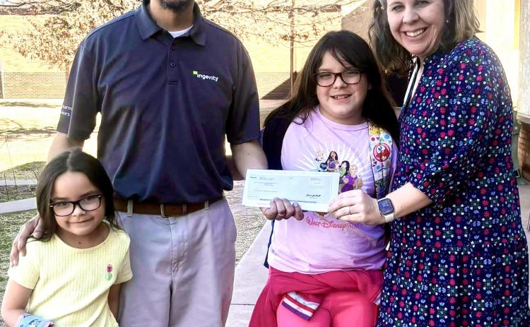 Ingevity Childress Chemical Plant employee Tony Lugo presents a check to Childress Elementary School Principal Tracey Blake. Funds will benefit the Childress Elementary School STEM lab, Blake said. Childress Elementary School