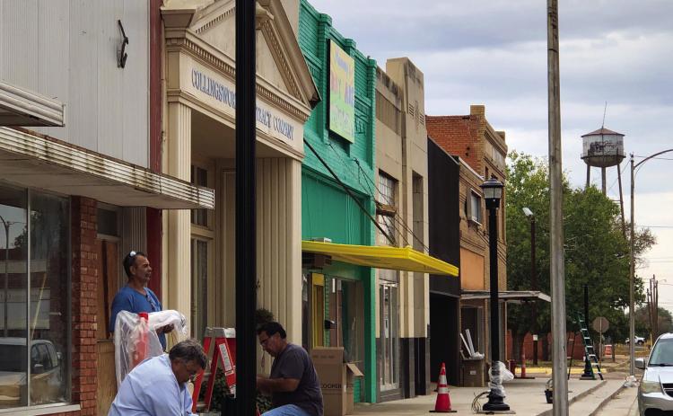 Crews erect downtown light poles