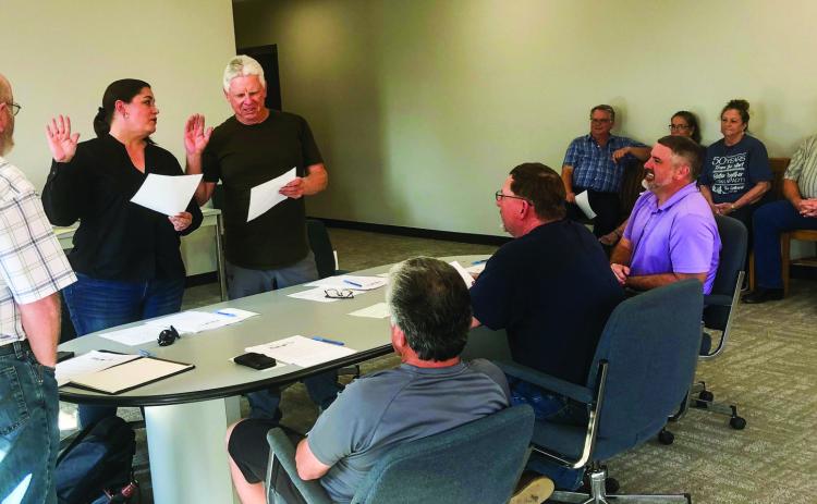 Administered by Mayor Larry Adams, left, City of Wellington Aldermen Julie Collins, second from left, and incumbent Kenneth Warren, take the Statement of Officer and the Oath of Office at the Monday, June 5 meeting. Councilmen Jimmy Cantu Jr., Brent Martin and Brandon Ward witness the event, plus visitors Neal Odom, Karen Caldwell, Margret Wood, Dave Hall and Chuck Darter. The Red River Sun/Bev Odom